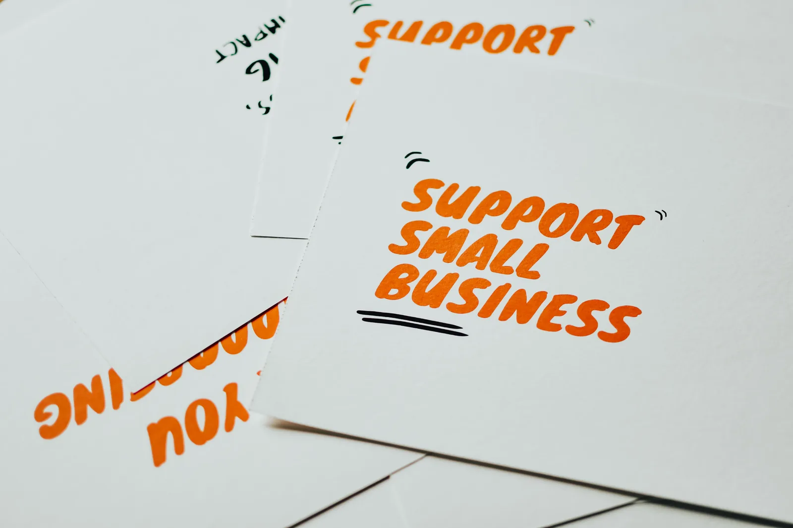 Close-up of motivational cards promoting support for small business on white background. Voiceover Startup: How Rates and Usage Rights Work